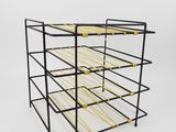 a black and yellow wire rack with six bottles of wine