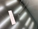 a piece of luggage sitting on the floor next to a ruler