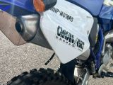 a close up of a motorcycle parked on the side of the road