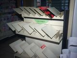 many boxes of pizza on the shelves in the store