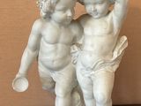 a statue of a boy and a girl on a table