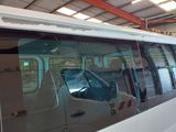 a white van parked inside of a building with a large window