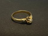 a close up of a gold ring on a black surface