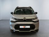 the front view of a silver citrole parked in a showroom