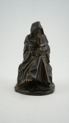 an image of a statue of a man sitting on a chair