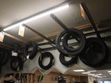 many tires hanging from the ceiling in a garage
