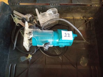 a blue electric drill sitting in a tool box