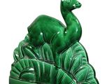 ceramic figurine of a deer on a leafy base