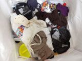 a white bag full of clothes and toys in it
