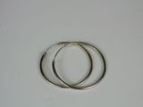 pair of silver hoop earrings on a white surface