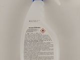 a spray bottle with a blue cap on it sitting on a white surface