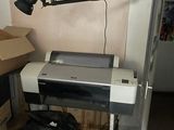 a printer sitting on a desk in the corner of a room