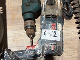 a picture of a drill and other tools on a table