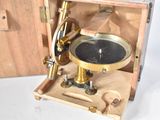 a wooden box with a brass plate inside of it