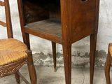 two chairs and a table with a drawer on top of it