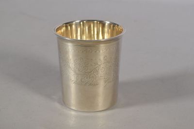 a silver cup that is sitting on a table