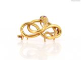 a close up of a gold ring with a snake on it