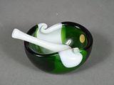 a green and white bowl with a pipe in it