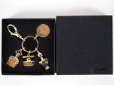 a black box with a gold keychain in it