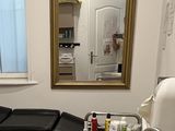 a room with a sink and a mirror in it