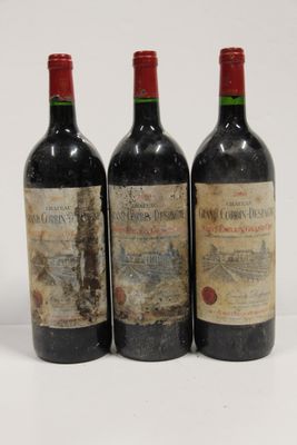 three bottles of wine are lined up on a white surface