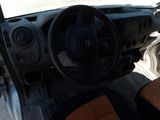 a steering wheel and dashboard of a vehicle in a parking lot