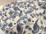 a close up of a blue and white floral pattern on a shirt