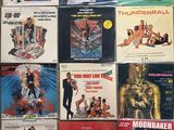 many different movie posters on a wall in a room