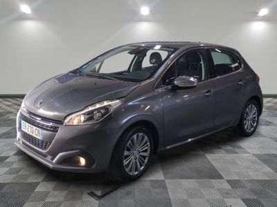the grey car is parked on a checkered floor in the garage