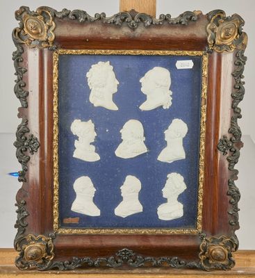 an antique framed picture of a group of silhouettes of people