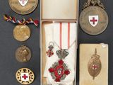 an assortment of medals and medals are displayed on a table