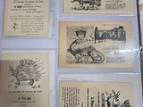 a person holding a bunch of old postcards on a table
