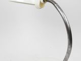 a white table lamp with a metal base and a white shade