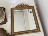 a bed with a mirror and a hat on top of it