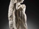 a statue of an angel holding a woman on a rock