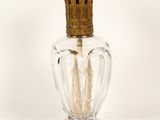 a glass vase with a gold crown on top of it