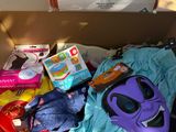 a cardboard box filled with toys and other items