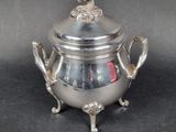 an antique silverplated teapot with handles and a lid