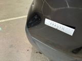 a sticker on the back of a car that is parked in a parking lot