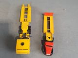 two toy trains sitting next to each other on a table
