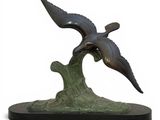 sculpture of two birds flying over a wave on a white background