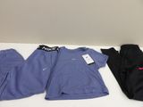 three pairs of nike scrubsuits and a t - shirt on a table
