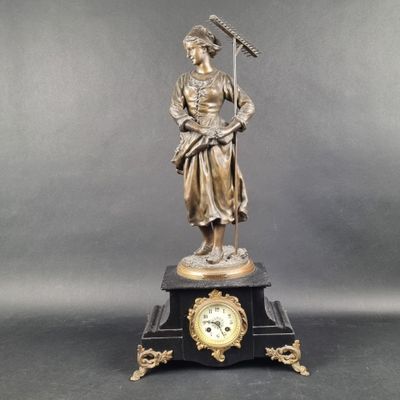 an image of a statue of a woman holding a clock