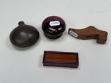 a small wooden object on a table next to other items