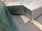 two stainless steel sinks in the middle of a parking lot