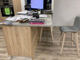 a desk with two chairs and a computer on it
