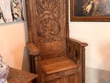 a chair and a table in a room with a painting on the wall