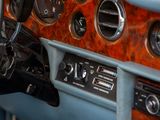 a close up of a car dashboard with various gauges and controls
