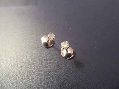 a pair of earrings sitting on top of a table