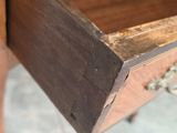 an old wooden desk with a drawer that has a drawer on top of it